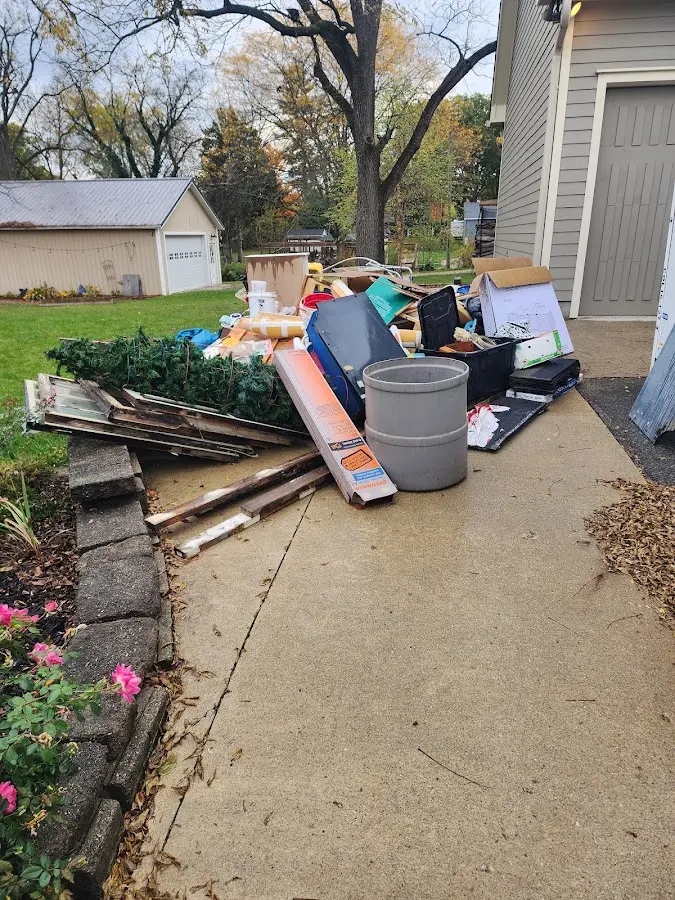 Dumpster being loaded with debris for 12 Yard Dumpster Rental in Delshire